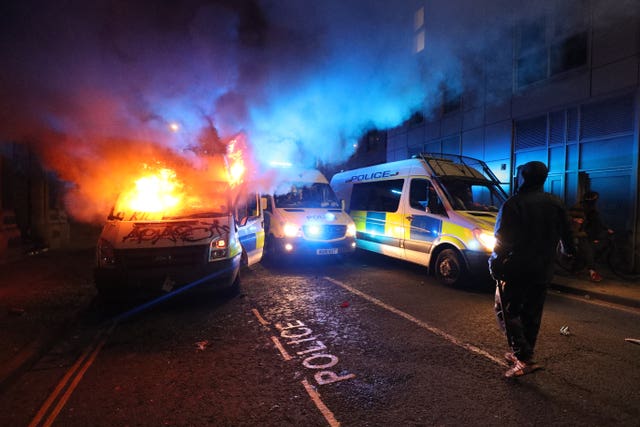 A vandalised police van on fire outside Bridewell police station in Bristol 