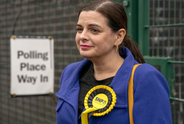 Katy Loudon wearing an SNP rosette outside a polling station