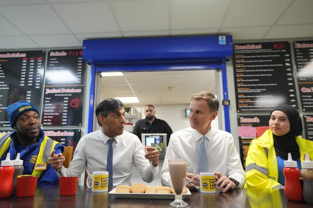 Prime Minister Rishi Sunak and Chancellor of the Exchequer Jeremy Hunt meet staff during a visit to a builders' merchant in south-east London, after the Chancellor delivered his Budget at the Houses of Parliament