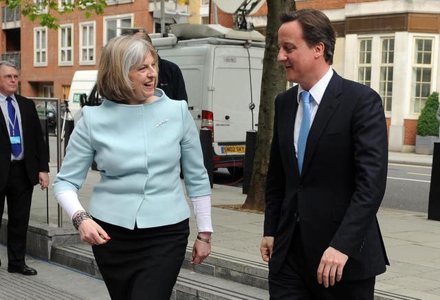 Home secretary Theresa May welcomes new prime minister David Cameron to the Home Office 