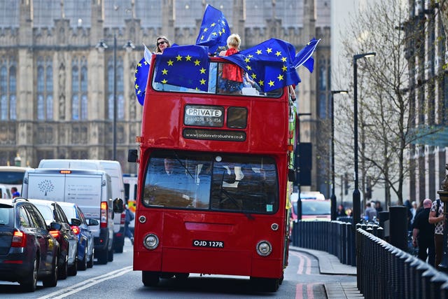 Remain supporters on board an open-top bus outside the Houses of Parliament