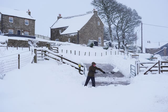 A man clears snow near Allenheads