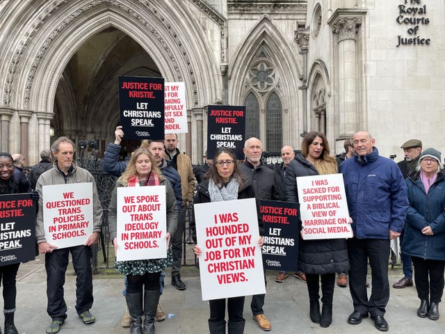 Kristie Higgs (centre), outside the Royal Courts of Justice with supporters holding placards