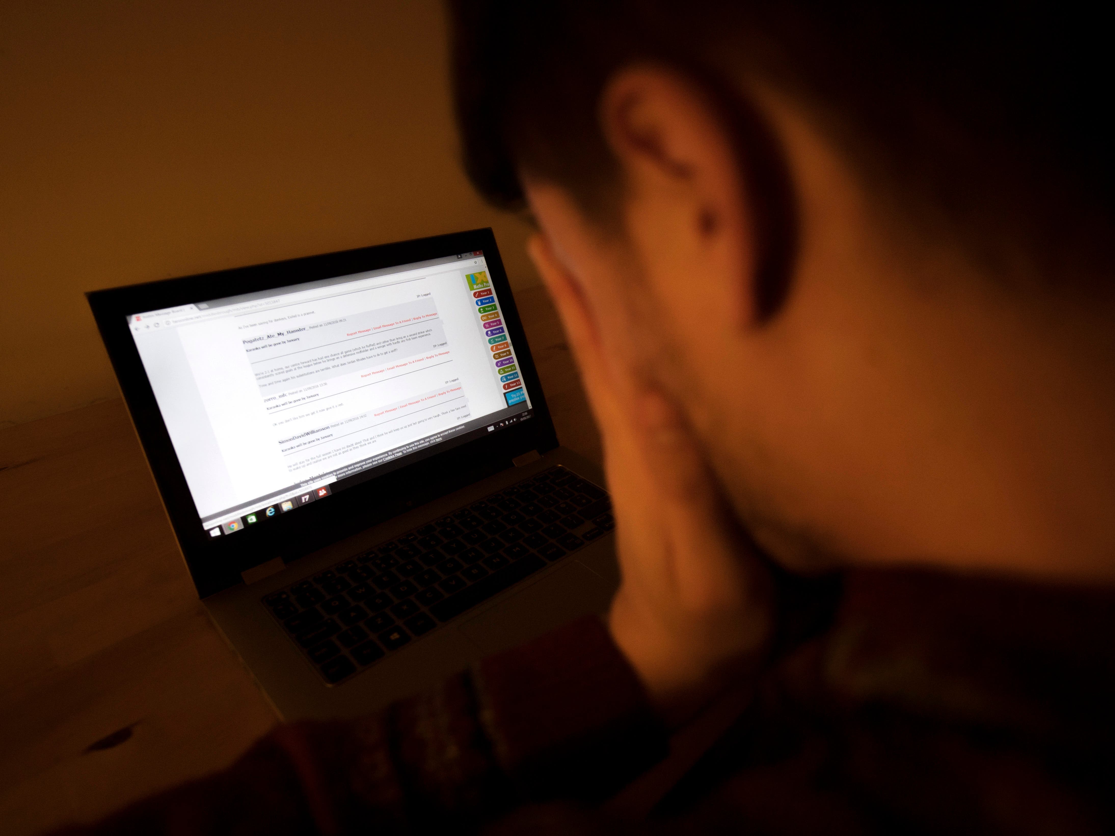 In a picture posed by a model, a man looks upset as he looks at a laptop computer