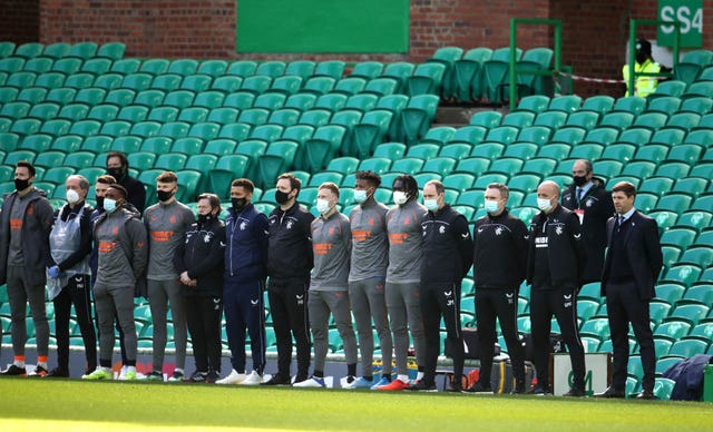 Rangers substitutes and staff line up on the touchline prior to the match