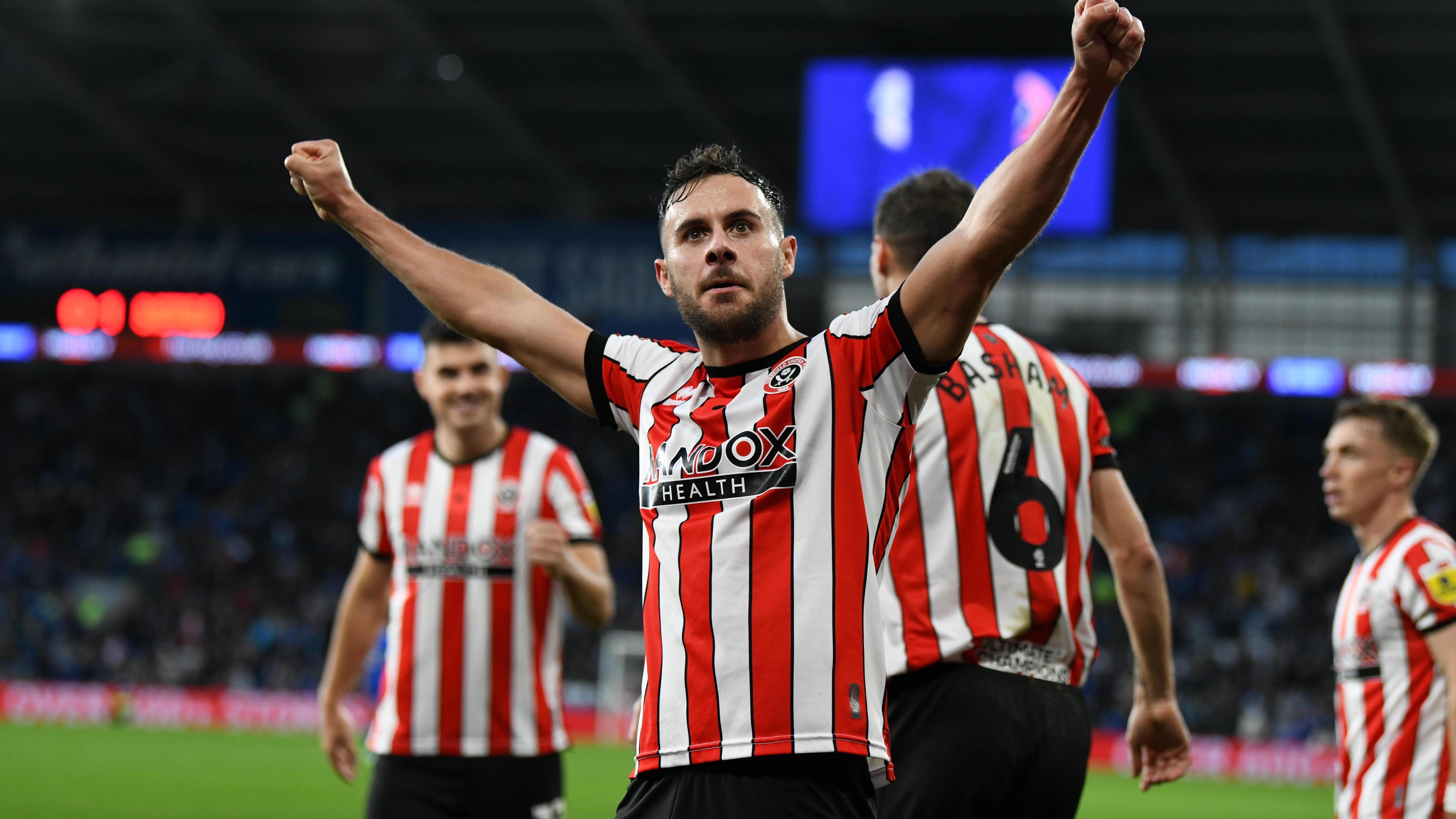 Sheffield United’s George Baldock celebrates his winner at Cardiff (PA)