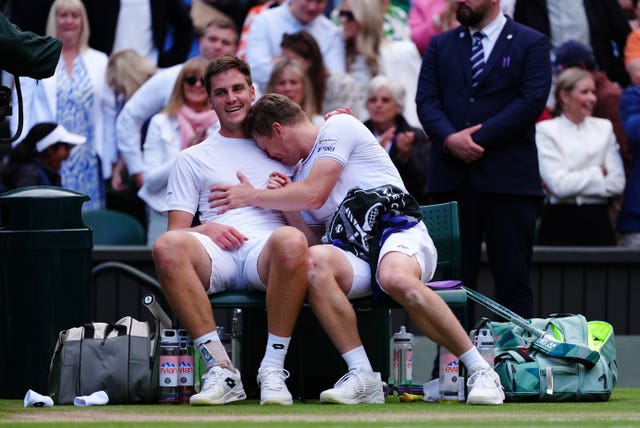 Harri Heliovaara hugs Henry Patten as they sit in their chairs