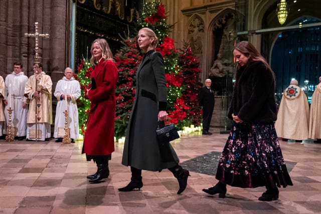 Lady Helen Taylor, Lady Gabriella Windsor and a third woman walk across the abbey 