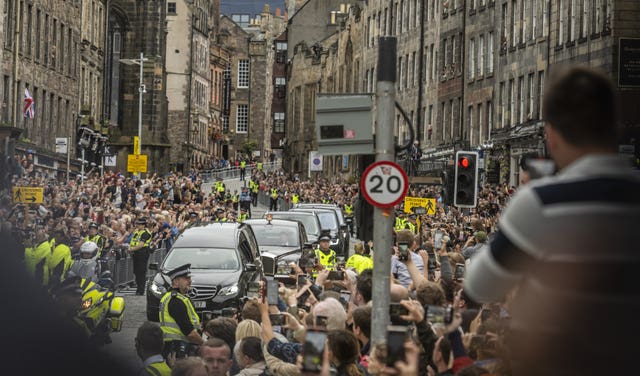 The hearse carrying the coffin of the Queen travels along the Royal Mile 