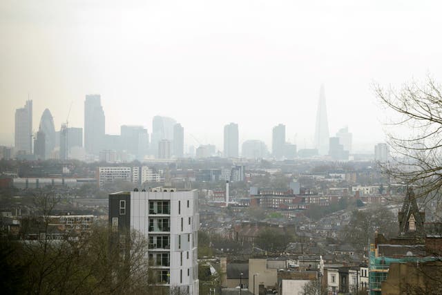 A view of the City of London skyline (including The Shard and the Gherkin buildings) as seen through a layer of smog, from north London (Yui Mok/PA)