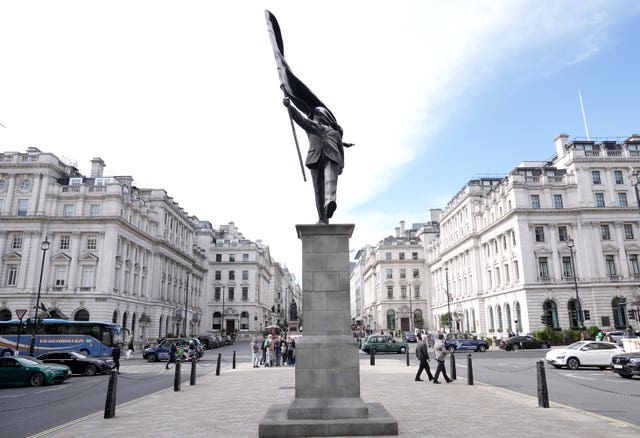 A statue of a man carrying a flag covering his face appeared in Waterloo Place near Trafalgar Square, claimed by Banksy