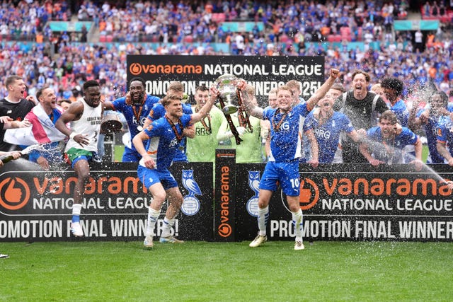 Oldham players celebrate promotion to the Football League at Wembley