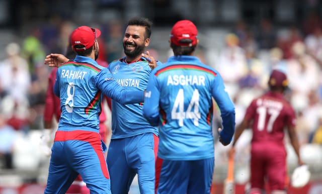 Dawlet Zadran (centre) celebrates the wicket of Chris Gayle