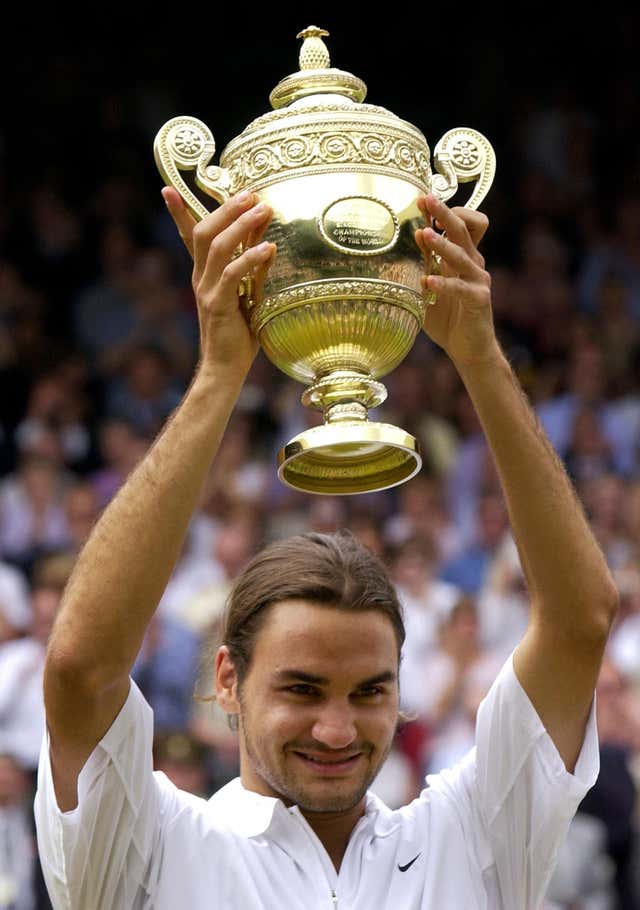 Federer celebrates after winning his first Wimbledon title. He saw off Mark Philippoussis in straight sets 