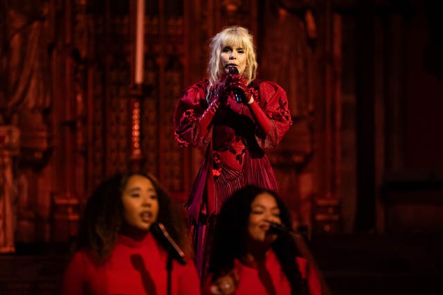 Paloma Faith in a red gown singing 