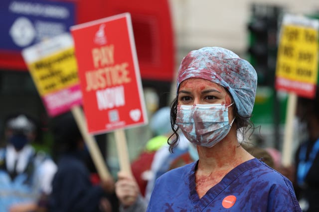 An NHS worker at a rally St Thomas’ Hospital, London