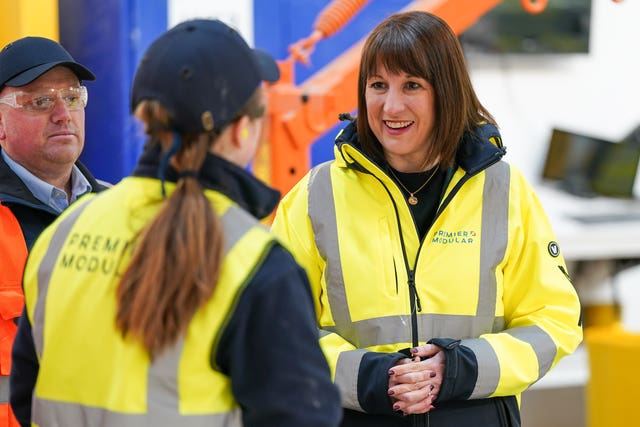 Chancellor Rachel Reeves speaking to a staff members during a tour of a manufacturing facility 