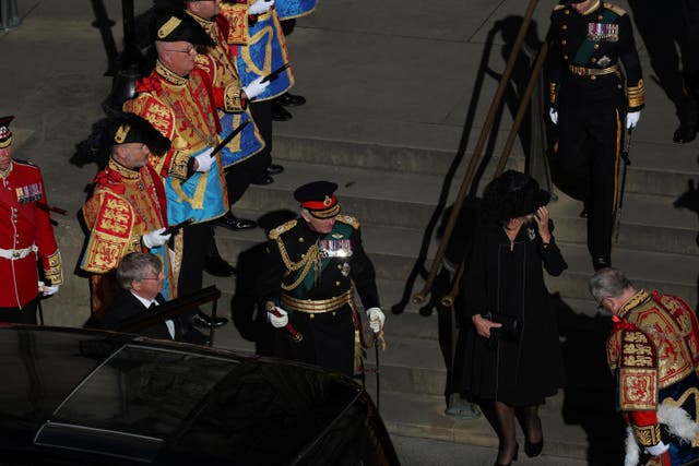 King Charles III and the Queen Consort leave after the service