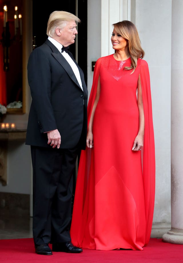 US President Donald Trump and his wife Melania wait to greet the Prince of Wales and the Duchess of Cornwall outside Winfield House, the residence of the Ambassador of the United States of America to the UK, in Regent’s Park, London, for the Return Dinner as part of his state visit to the UK.