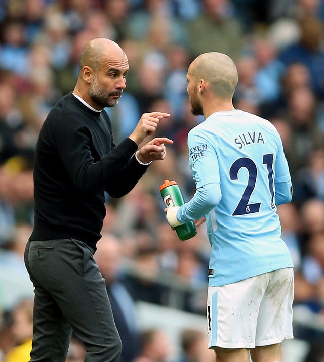 Silva (right) has thrived under Pep Guardiola (left)