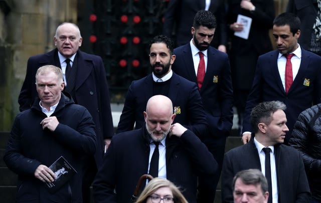 Mourners including Paul Scholes, left, and Ruben Amorim, centre, leave Manchester Cathedral following the funeral of Denis Law