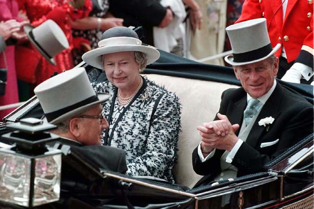 The late Queen Elizabeth II and the late Duke of Edinburgh with Mr Kissinger on their arrival for the first day of Royal Ascot in June 1995 