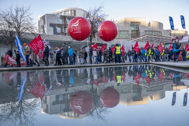 Members of the Unite union march and rally at the Scottish Parliament in protest at Petroineos plans to close Grangemouth oil refinery