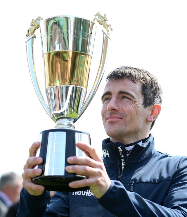 Hughes holding the trophy last season 