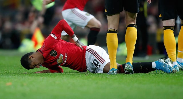 Marcus Rashford lies injured against Wolves