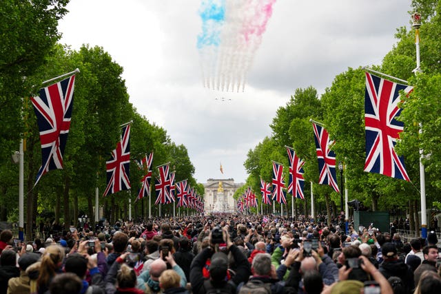 Members of the public along the Mall watch the flypast to mark the 80th anniversary of VE Day 