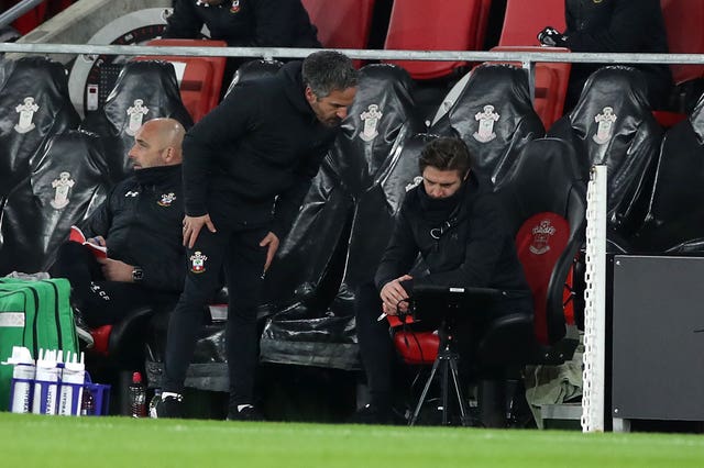 Coaches in conversation on Southampton bench during West Ham fixture