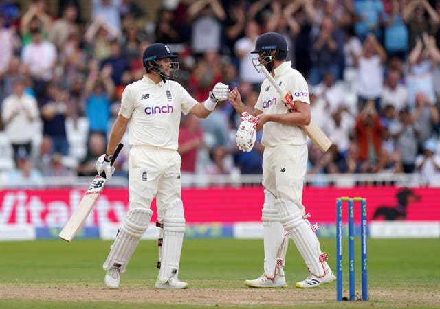 England's Joe Root celebrates his 50 with team-mate Dom Sibley 