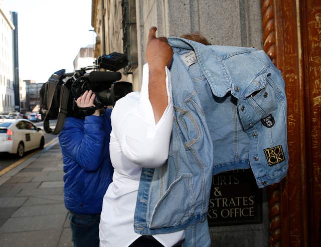 Joan Jacob covers her head as she arrives at court (Owen Humphreys/PA)