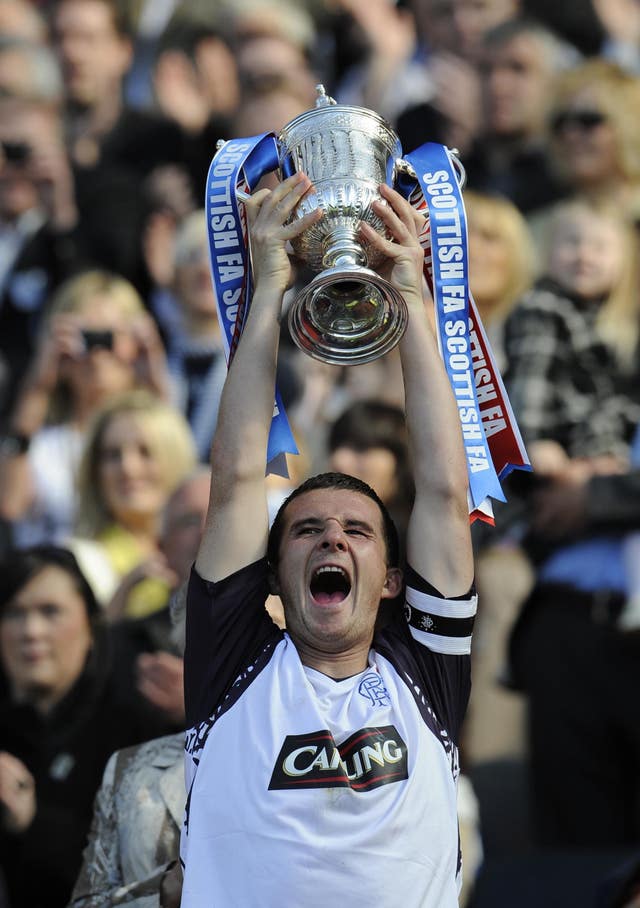 Rangers’ captain Barry Ferguson lifts the trophy following Scottish Cup final victory over Queen of the South