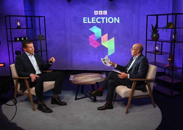 Rhun ap Iorwerth, leader of Plaid Cymru, talks to presenter Nick Robinson in a studio during a BBC General Election interview Panorama special 