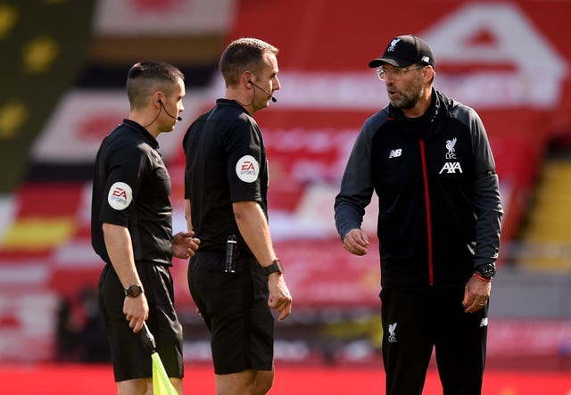 Liverpool manager Jurgen Klopp (right) with referee David Coote (centre). at a match in July 2020