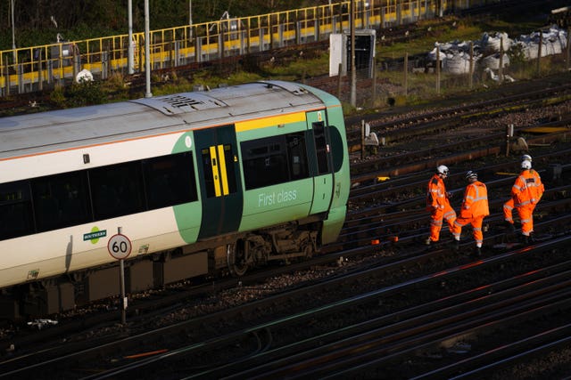 Engineers near a derailed train