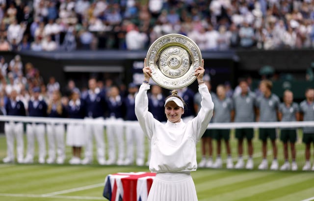 Marketa Vondrousova holds aloft the Venus Rosewater Dish after winning Wimbledon