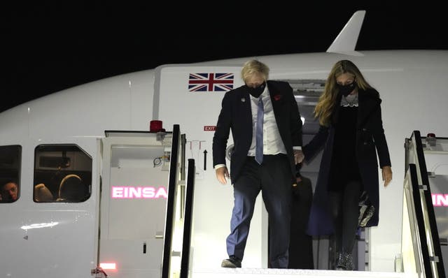 Prime Minister Boris Johnson, pictured with his wife Carrie, spoke with reporters about the French fishing row while travelling to Rome for the G20