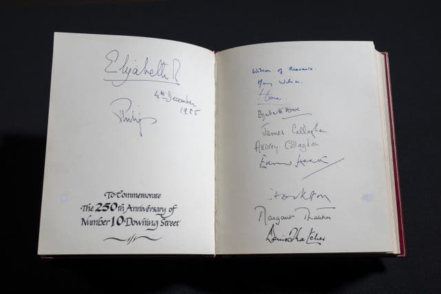 The pages marking the 250th anniversary of Downing Street with signatures of the Queen, Prince Philip, the Wilsons, The Humes, the Callaghans, Edward Heath, the Earl of Stockton, and Margaret and Denis Thatcher are seen in one of three Downing Street Visitors Books at the National Archives