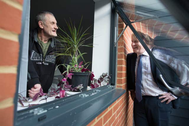 Prime Minister Boris Johnson speaks to Paul O’Rourke, who served with the Royal Irish Rangers, during a visit to a veterans centre in Salisbury 