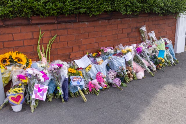 Floral tributes against a wall