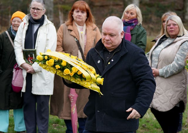 Peter McMahon carrying a wreath