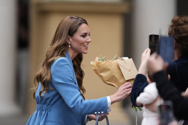 Kate receives a bouquet from a wellwisher