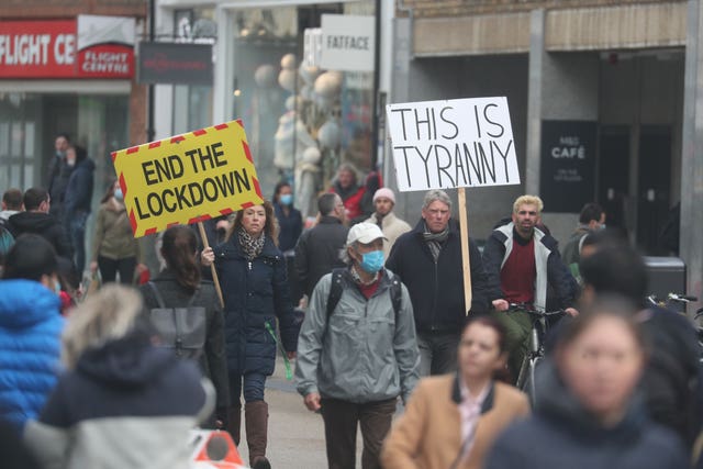 People walk with banners during a demonstration in Oxford, to protest against coronavirus lockdown restrictions (Steve Parsons/PA)