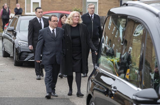 Sarah and Sean Baker, the parents of Jessica Baker, walk behind the hearse as it arrives at St Theresa’s Catholic Church in Chester for the funeral of the 15-year-old who died in the school-run coach crash on the M53 in Wirral