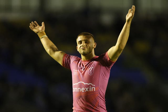 Mikey Lewis holds his arms up above his head