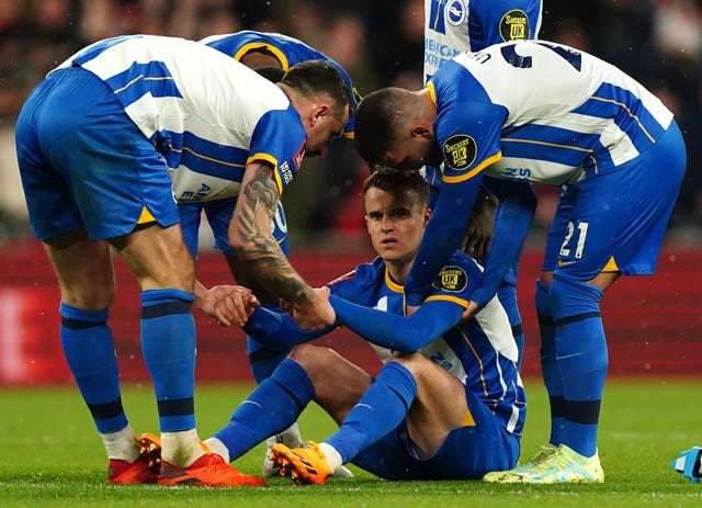 Brighton's Solly March, sitting, was the only player to miss in the semi-final shoot-out