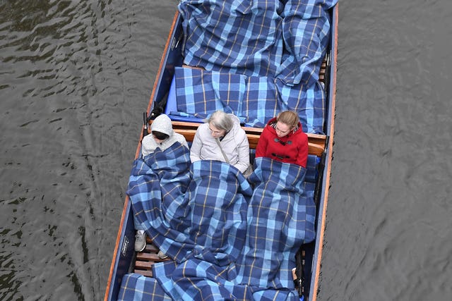Wrapping up warm for a punt along the River Cam in Cambridge