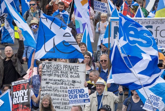 Scottish independence supporters march through Glasgow during an All Under One Banner march